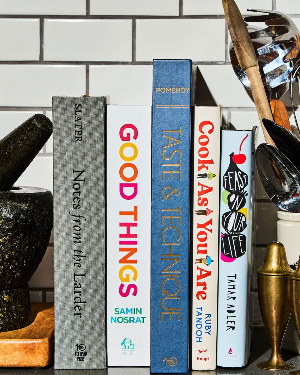 A stack of cookbooks in a kitchen